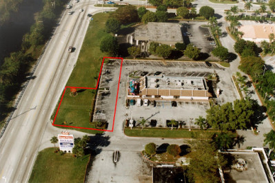 Image of an aerial view of a piece of parking lot taken by eminent domain from a fast food restaurant.