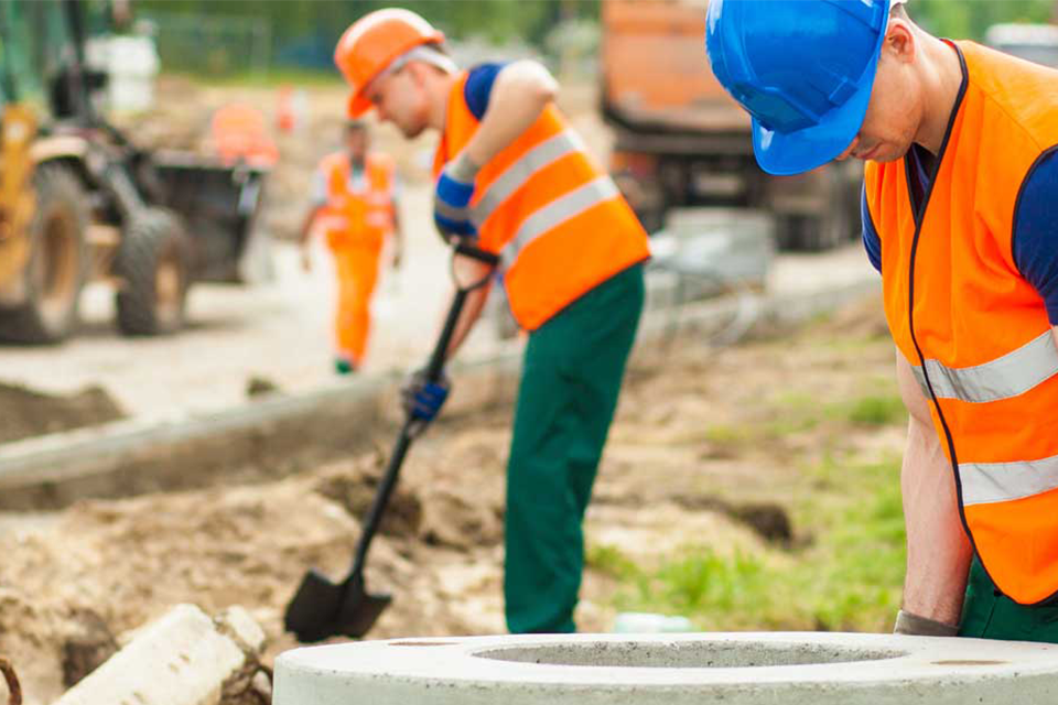 Picture depicting construction workers expanding a public road onto private property.