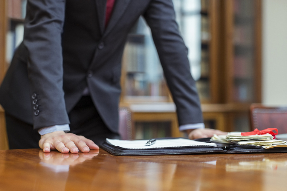 Image of a man presenting exhibits for evidence in court.